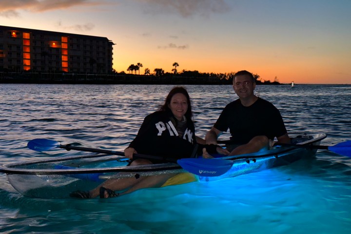 a group of people in a small boat in a body of water