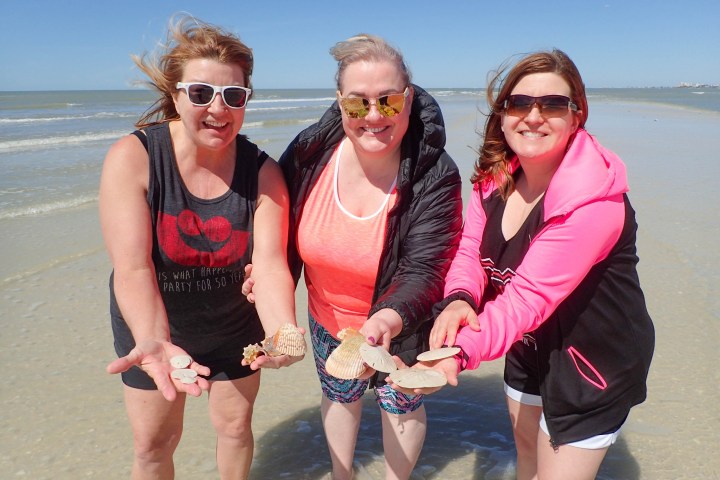 a couple of people that are standing in the water