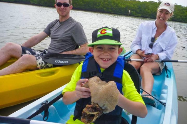 a small child sitting on a boat in the water
