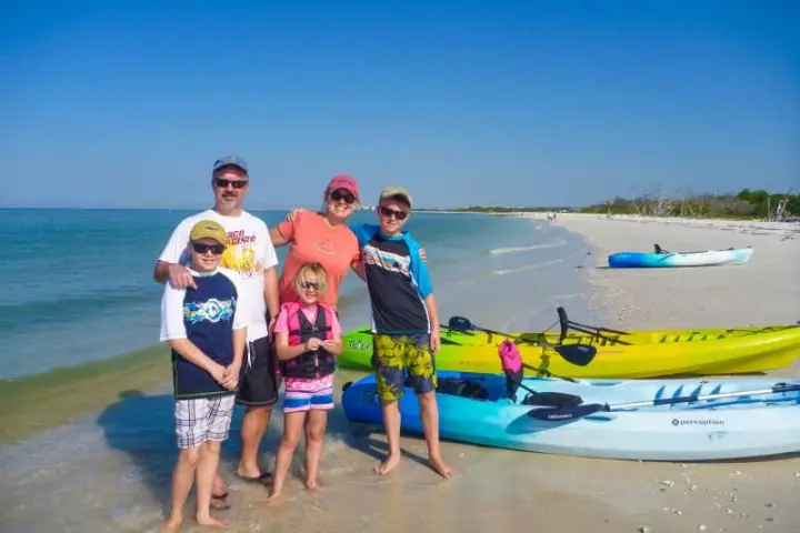 a group of people standing on a beach