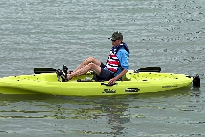 a person riding on the back of a boat in the water