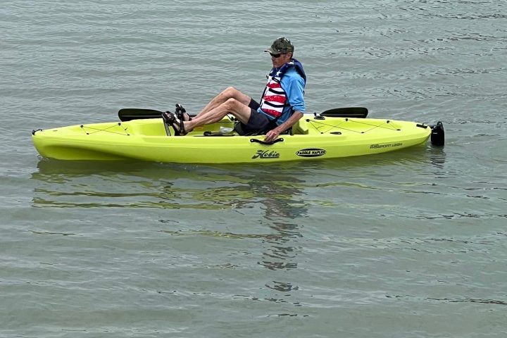 a person riding on the back of a boat in the water