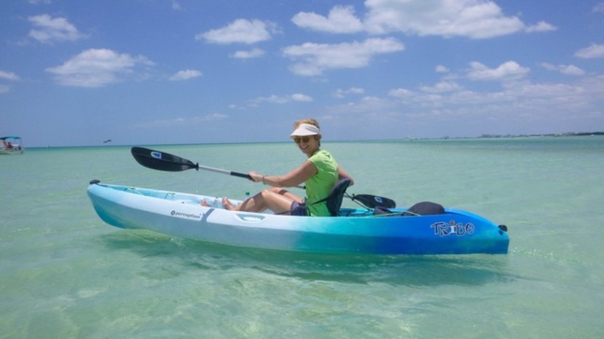 a person riding on the back of a boat in the water